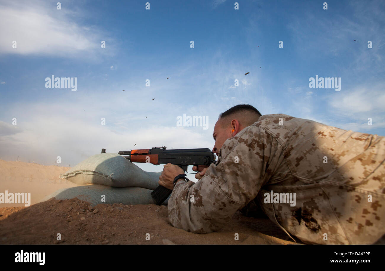 U.S. Marine Corps Sgt. Phillip Noble with Regimental Combat Team 7 engages his target during a foreign weapons and NATO ballistics live-fire shoot on Camp Leatherneck, Helmand province, Afghanistan, July 1, 2013. The Marines conducted the shoot to ensure Stock Photo
