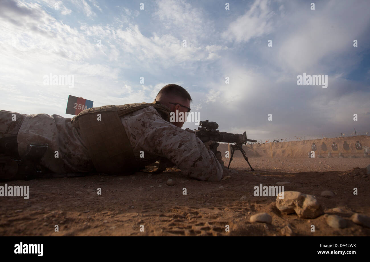 U.S. Marine Corps Staff Sgt. Jeremy Masters from Little Rock, Ark., and assigned to Regimental Combat Team 7 prepares to engage Stock Photo