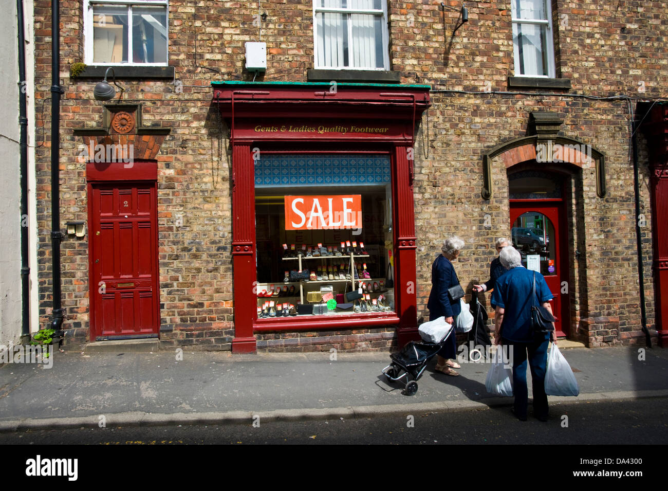 Shoppers outside traditional shoe shop in Malton Ryedale North Yorkshire  England UK Stock Photo - Alamy
