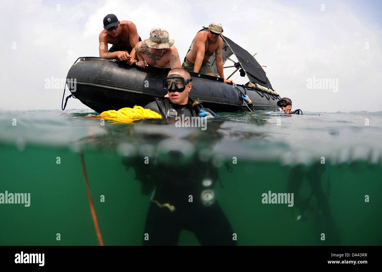 US Navy Divers before a recovery search dive during a Joint POW/MIA Personnel Accounting Command recovery mission May 30, 2010 in Quynh Phuong, Vietnam. The mission of the JPAC is to account of all Americans missing as a result of the nation's past wars. Stock Photo