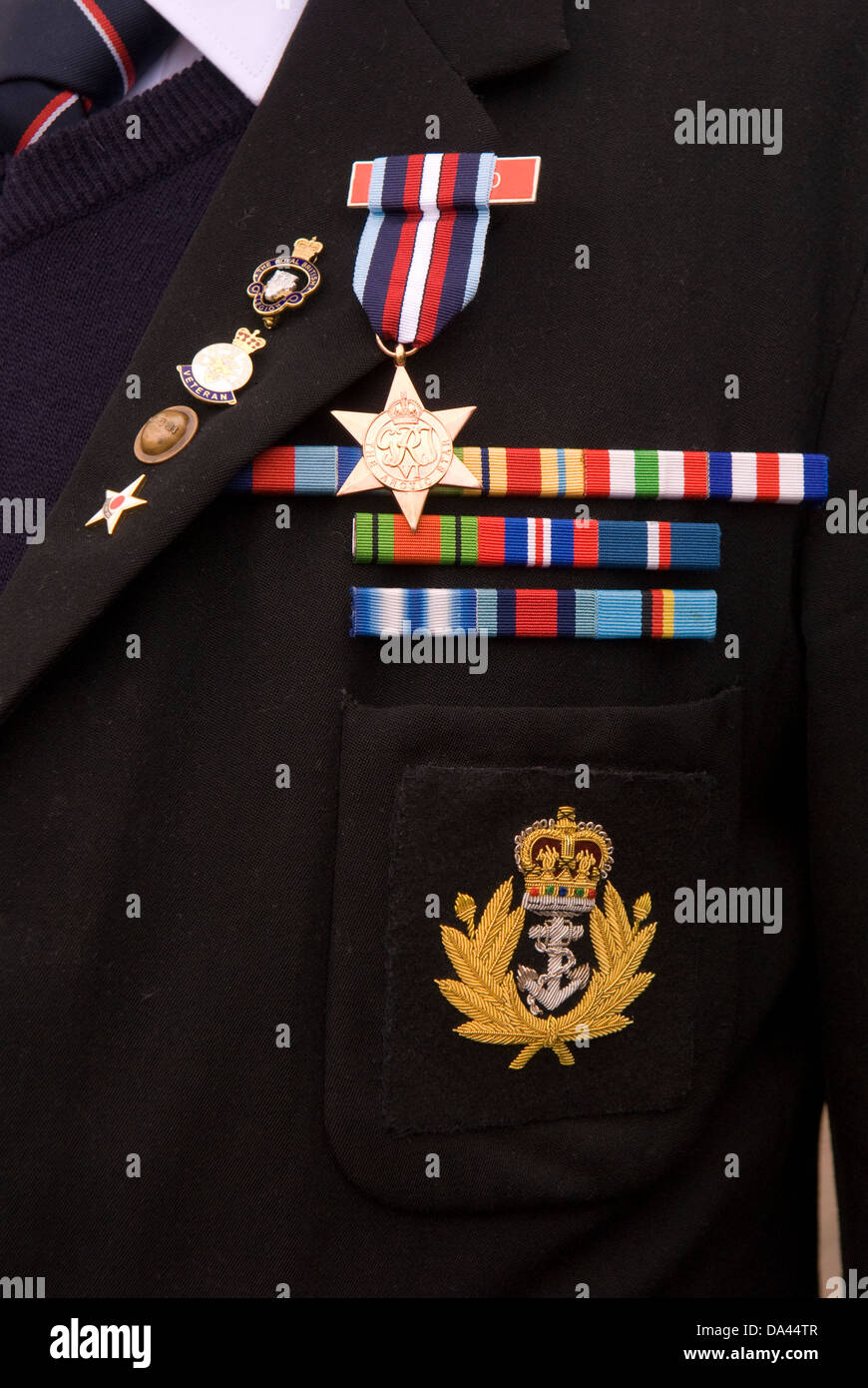 World War Two veteran wearing his Arctic Star medal badges and stripes, Bordon, Hampshire, UK. Stock Photo