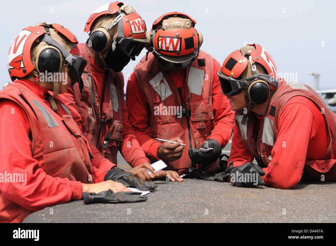 US Navy aviation ordnance men debrief after loading aircraft weapons during flight operations aboard the aircraft carrier USS Nimitz June 19, 2013 in the Gulf of Oman. Stock Photo