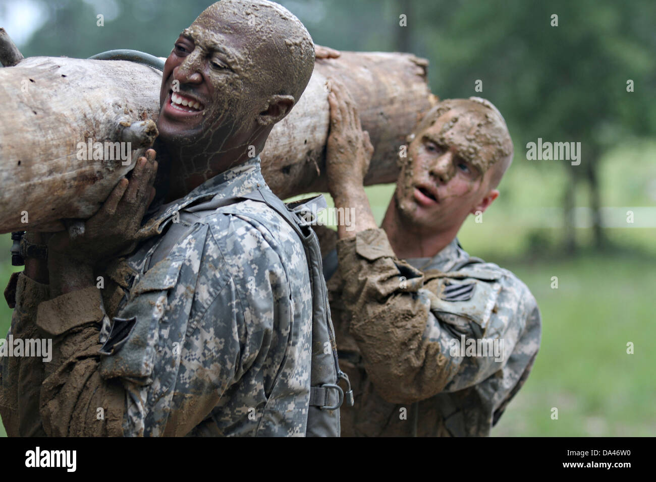 US Army soldiers with the 3rd Infantry Division carry a log during
