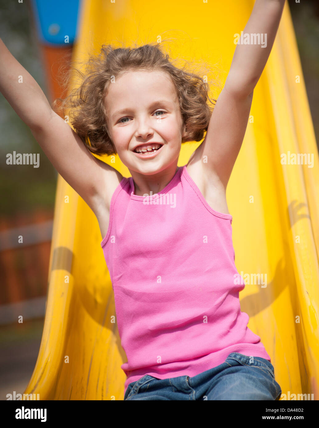 Close-up view of young girl on slide in playground Stock Photo - Alamy