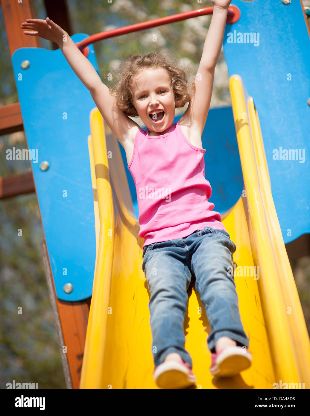 Close-up view of young girl on slide in playground Stock Photo - Alamy