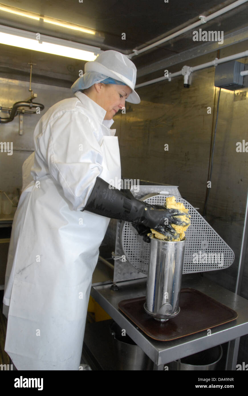 Worker making organically made butter from unpasteurized milk on