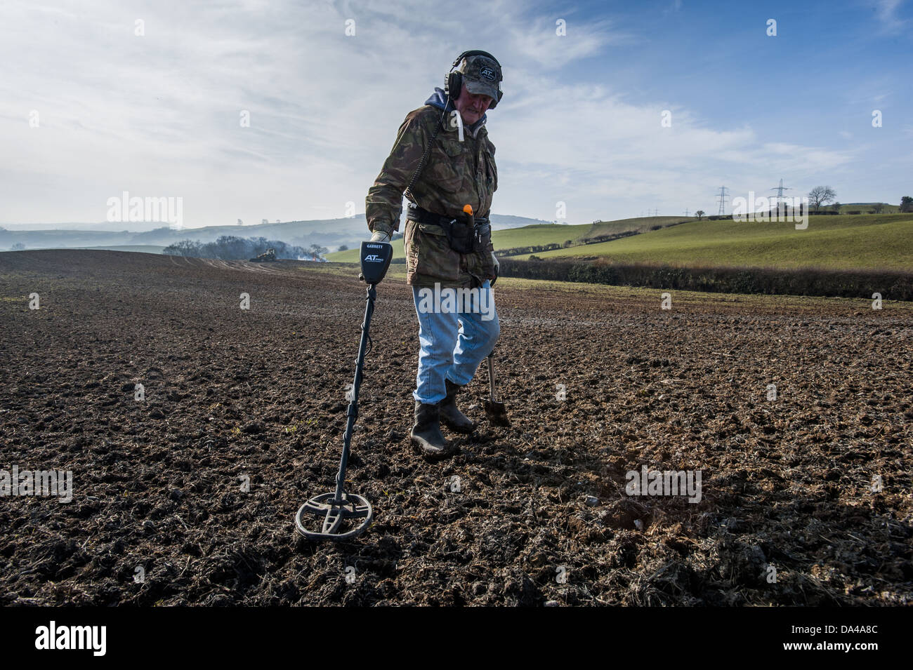 Man using metal detector in field, Llanfair Llanfair Talhaiarn, Conwy