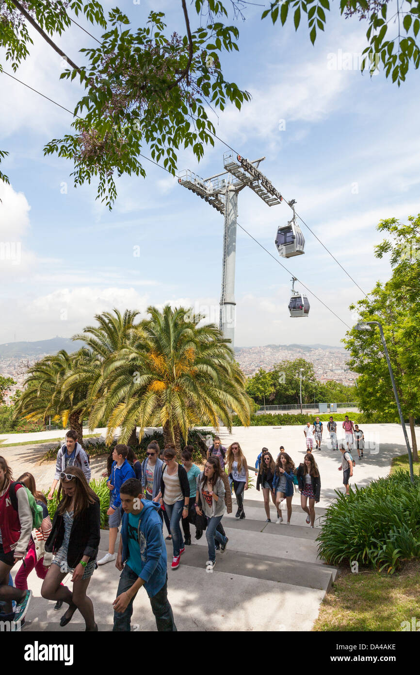 Tourists walking under Montjuic cable car tower Barcelona panorama ...