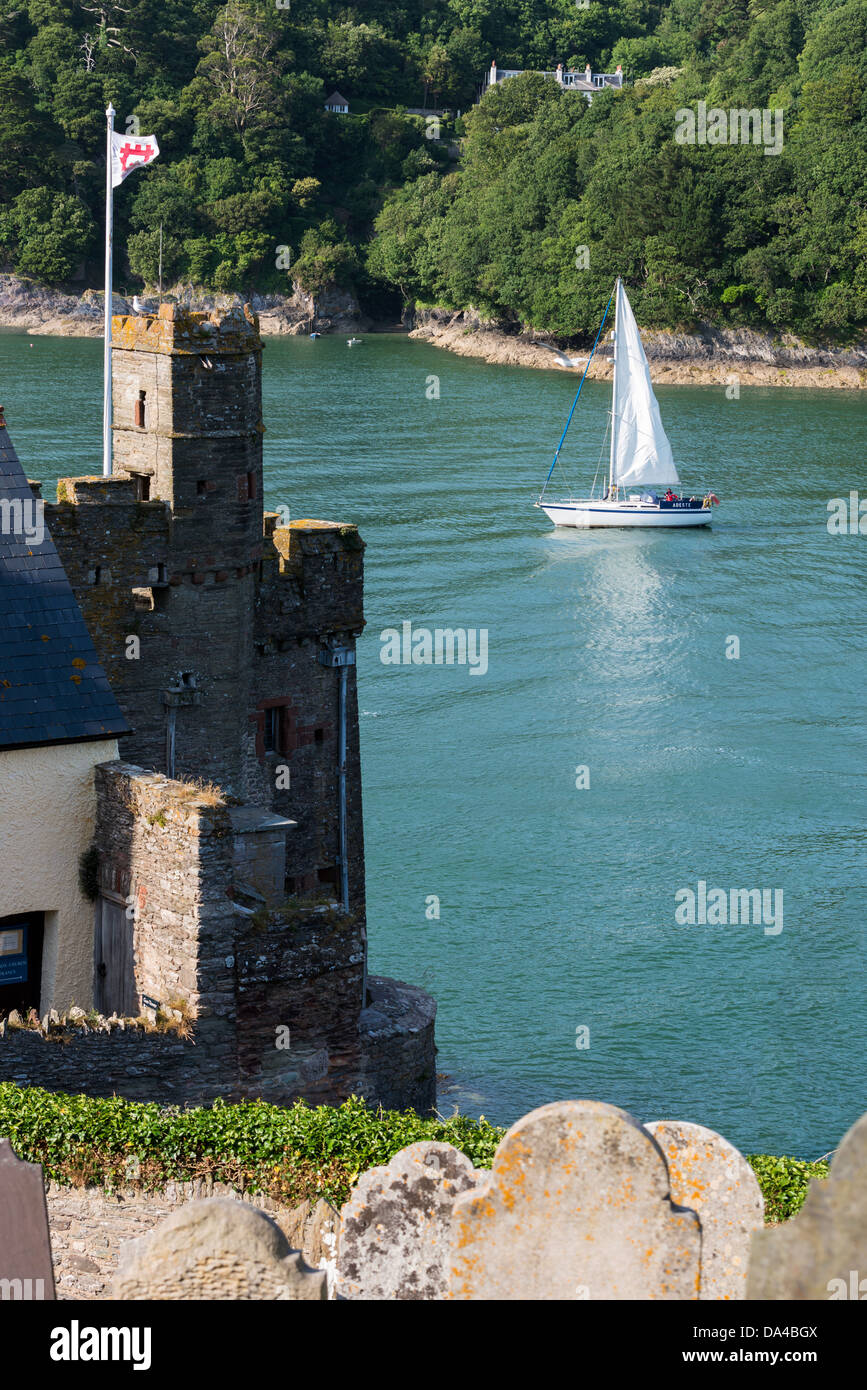 Dartmouth, Devon, England. July 1st 2013. A yacht sails by St Petrox church and graveyard at the mouth of the River Dart. Stock Photo