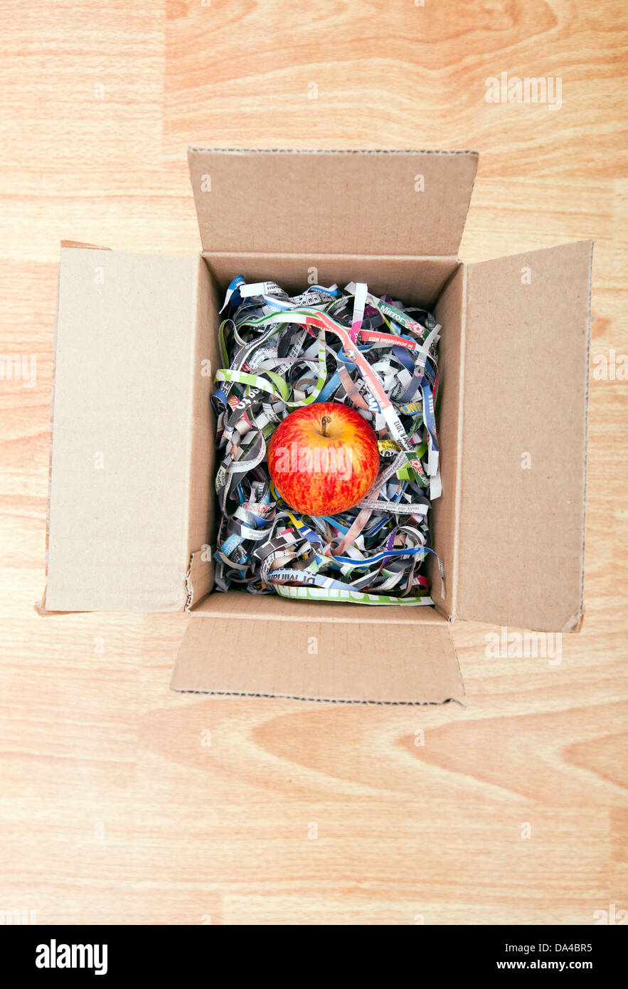 Apple wrapped up in a box Stock Photo