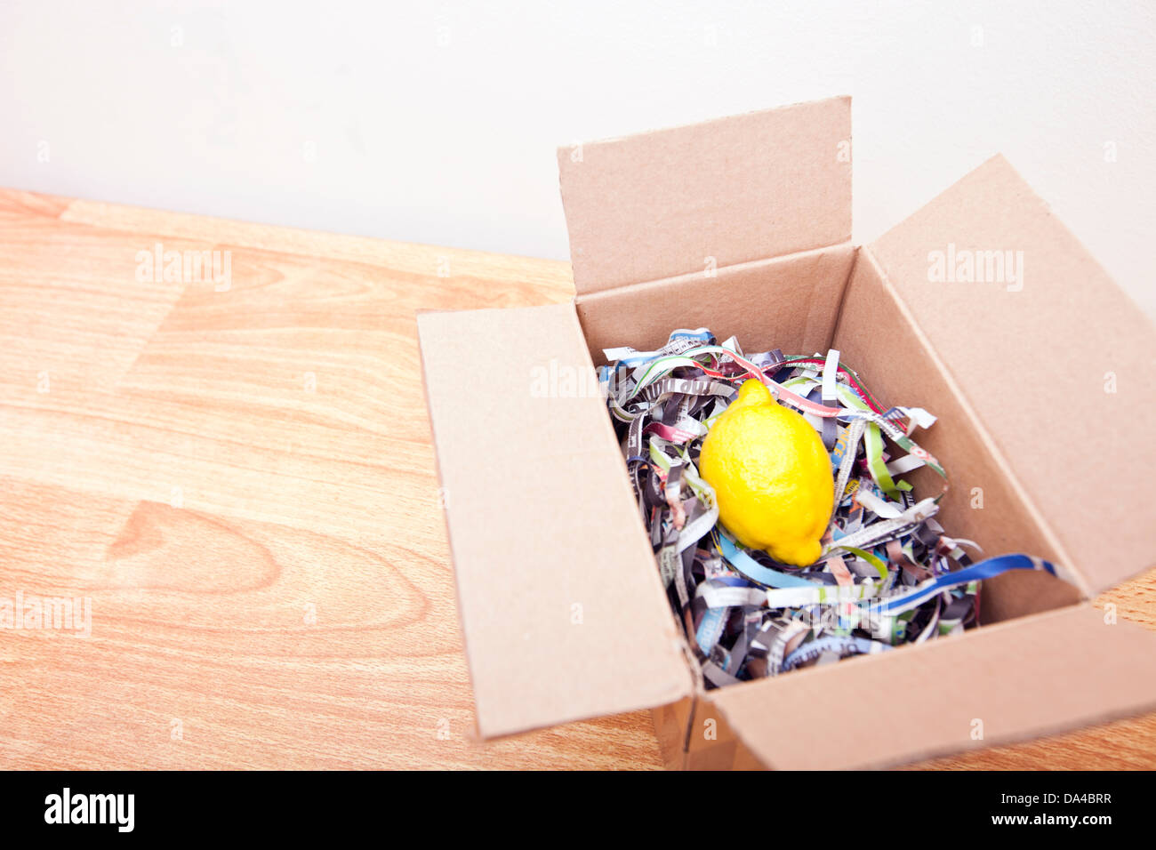 Lemon wrapped up in a box Stock Photo