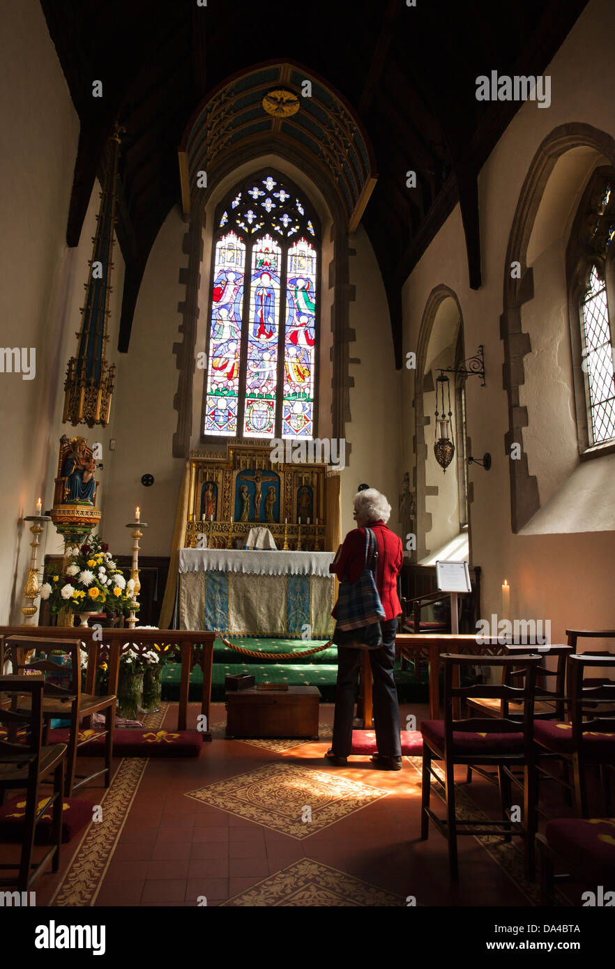 A woman inside the Slipper Chapel Shrine at Houghton St. Giles near Little Walsingham in Norfolk