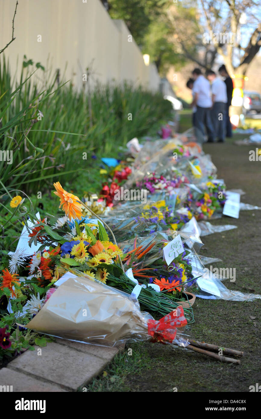 Johannesburg, South Africa. 03rd July, 2013. Members of the public gather outside Nelson Mandela's house in Houghton, Johannesburg. People are leaving well-wishes for the former South African President who is in a Pretoria hospital with a reoccurring Lung condition. Credit:  Jonny White/Alamy Live News Stock Photo