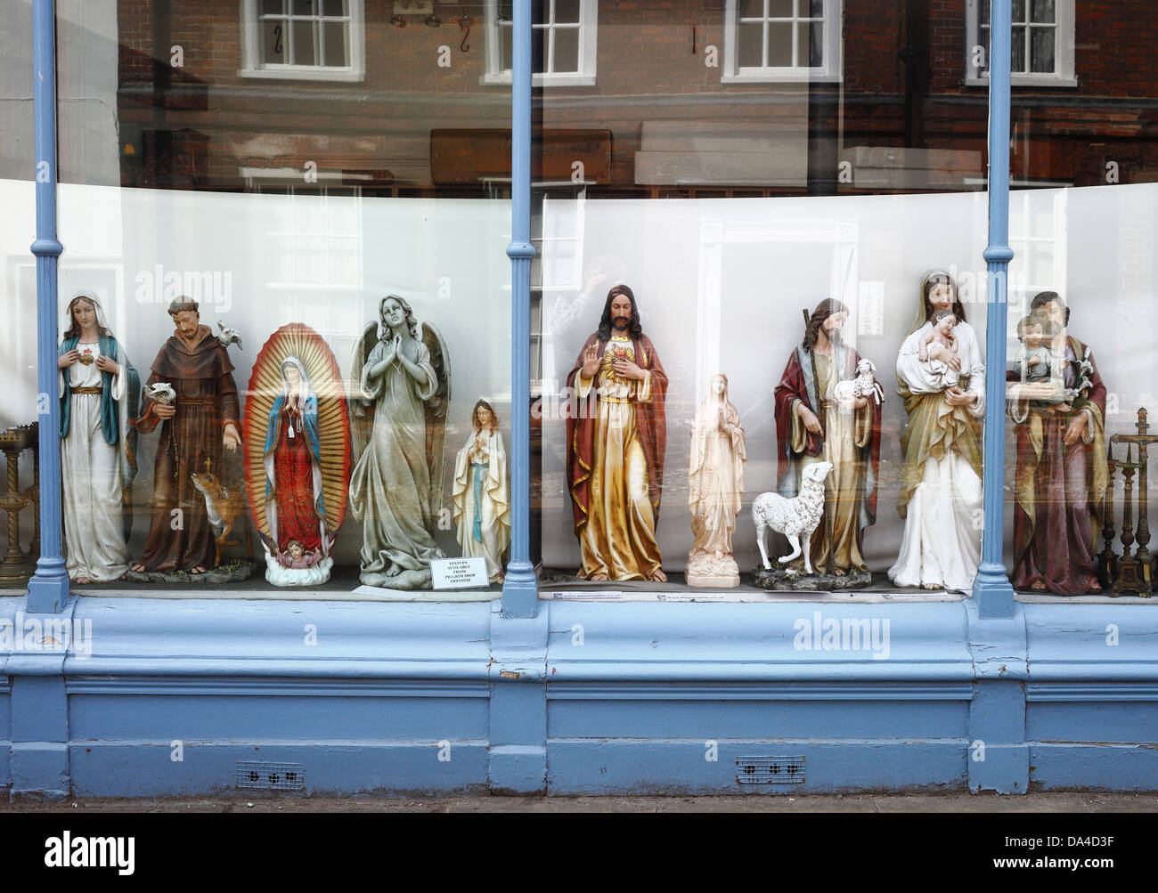 Religious statues on display in a shop window Stock Photo Alamy