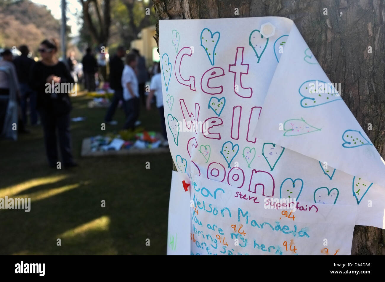 Johannesburg, South Africa. 03rd July, 2013. Members of the public gather outside Nelson Mandela's house in Houghton, Johannesburg. People are leaving well-wishes for the former South African President who is in a Pretoria hospital with a reoccurring Lung condition. Stock Photo