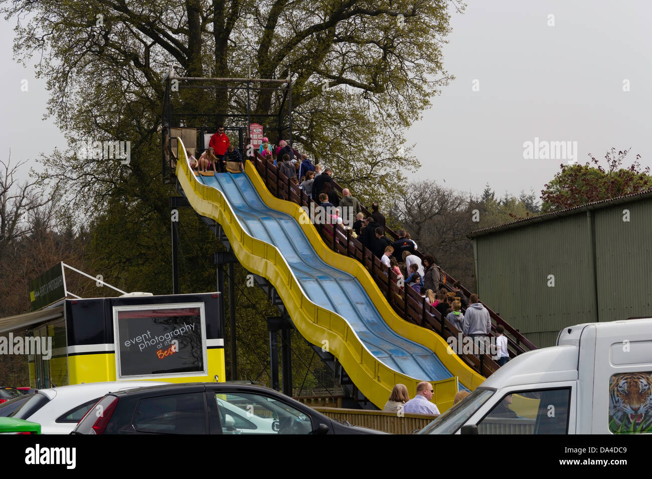 A slide with kids and parked cars inside the Blair Drummond safari
