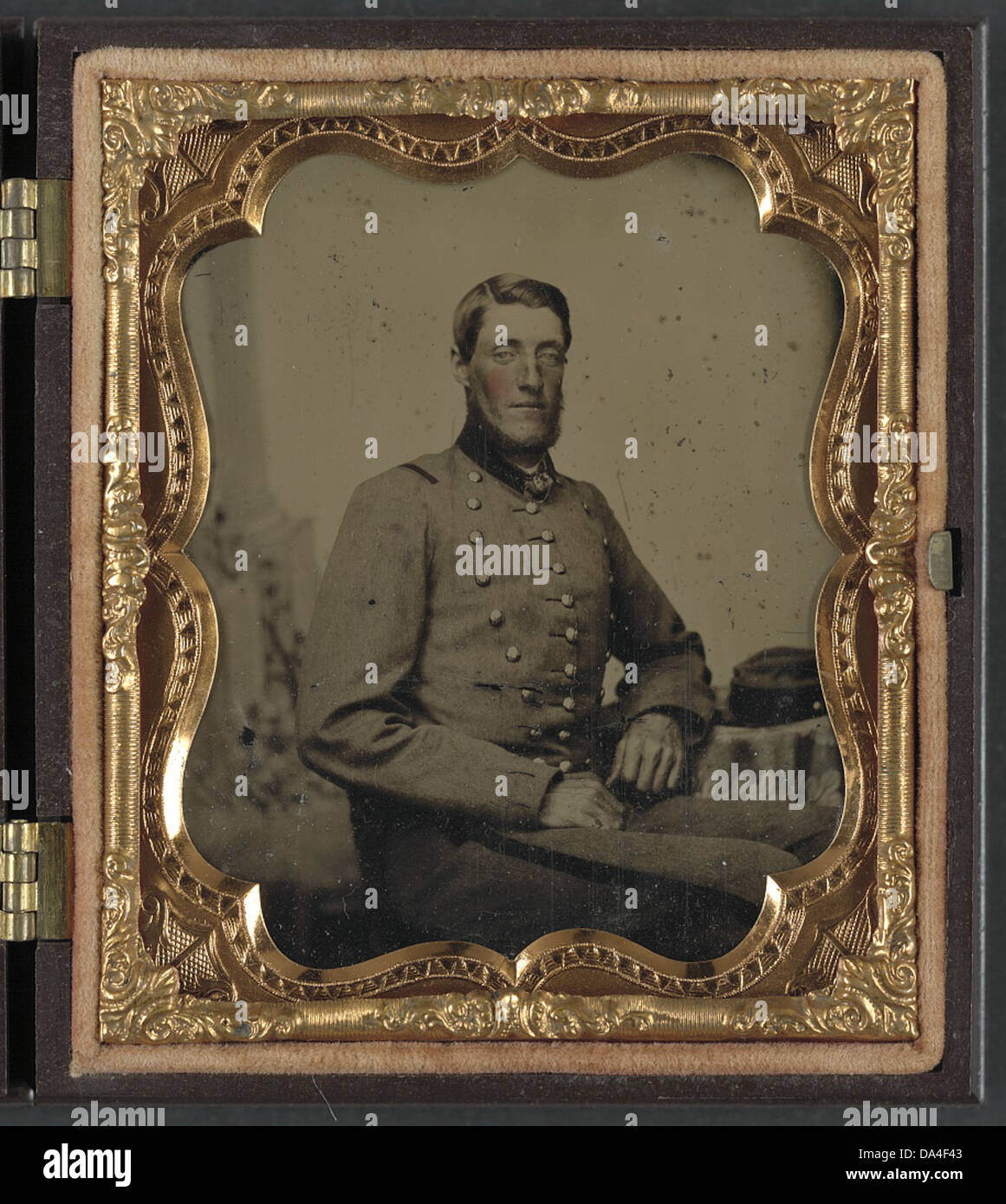 This photograph shows an unidentified Confederate soldier wearing a ...