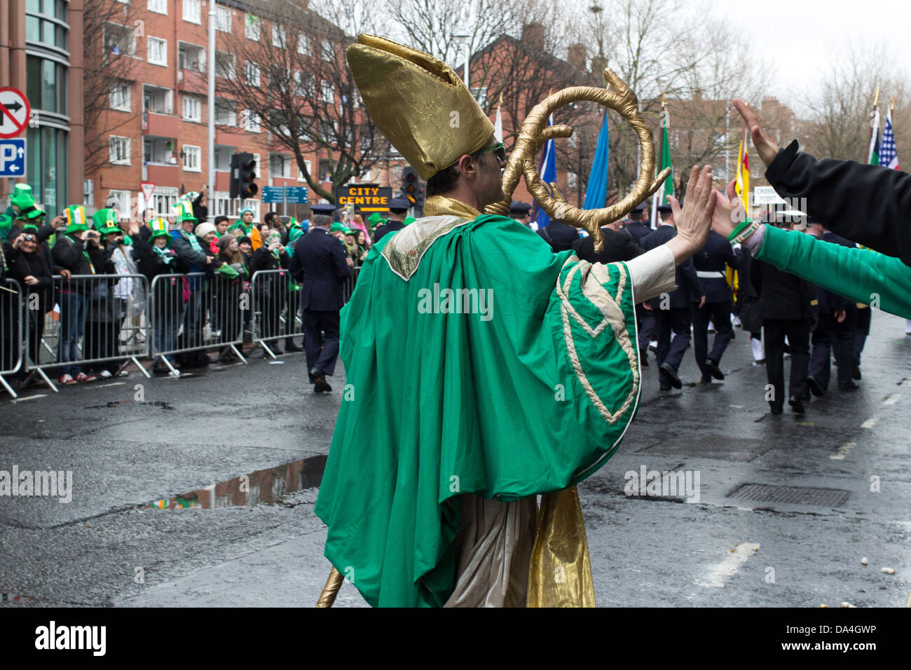 A man wearing St. Patrick's outfit gives a 'high-five' to a spectator, Dublin, Ireland, St. Patrick's Parade, 2013. Stock Photo