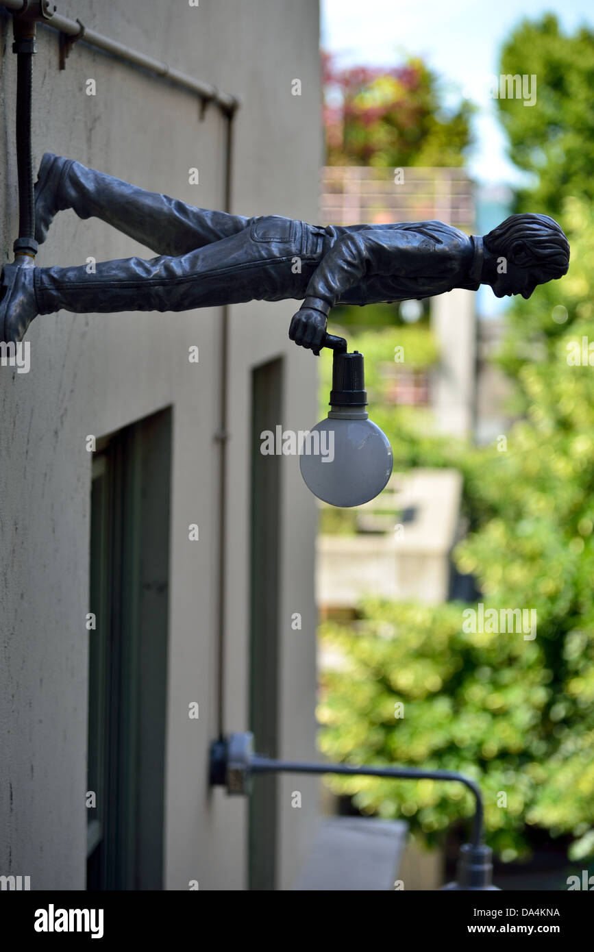 A statue mounted on the wall to hold street light. Seattle, Washington, USA  Stock Photo - Alamy