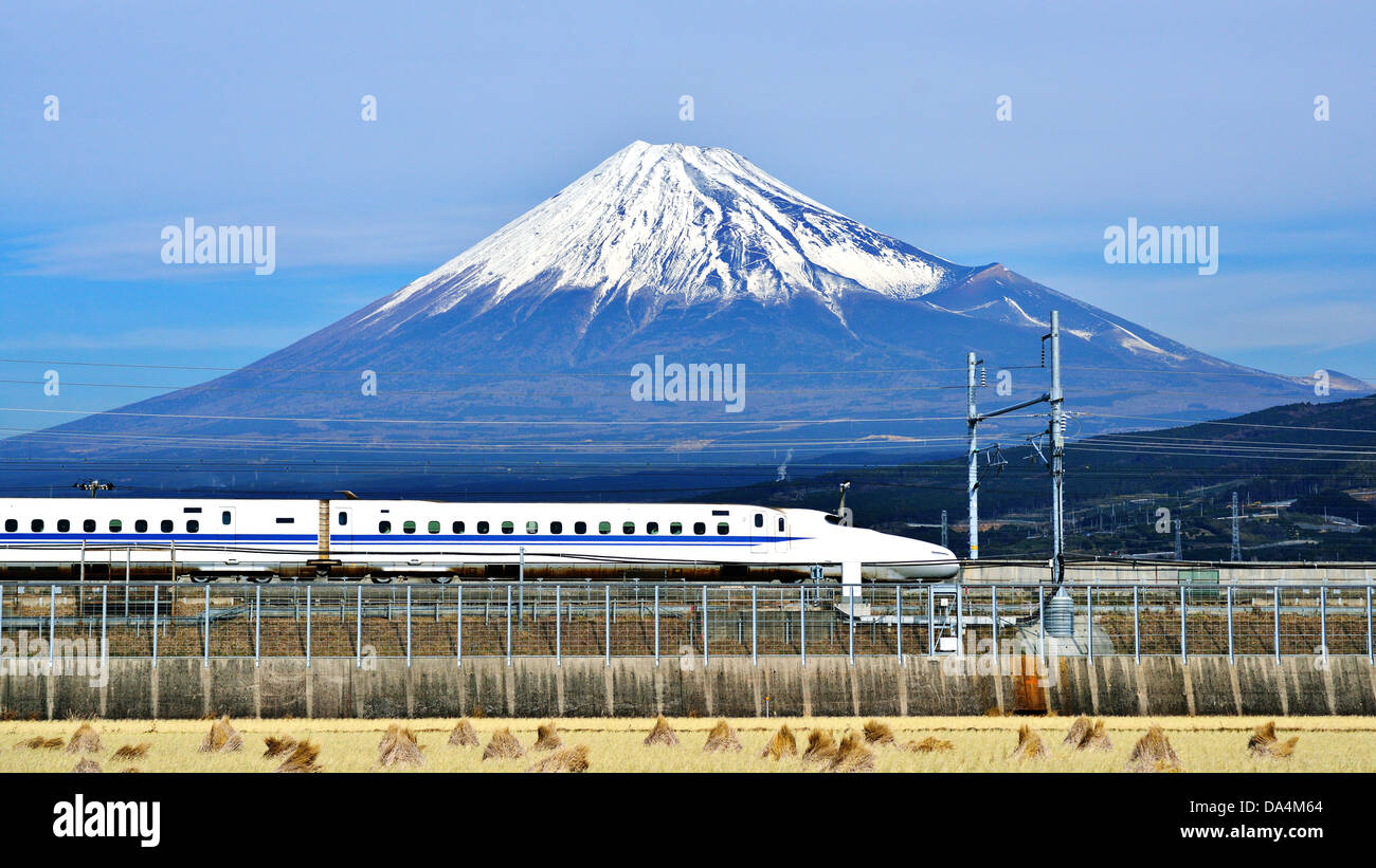 A bullet train passes below Mt. Fuji in Japan. Stock Photo