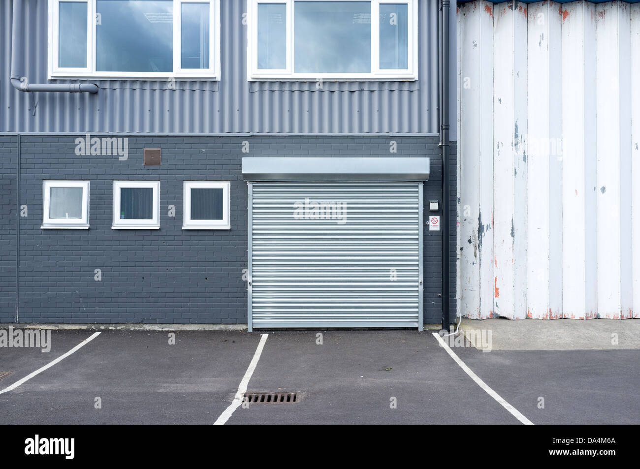 Aluminium security roller shutter on industrial unit UK Stock Photo