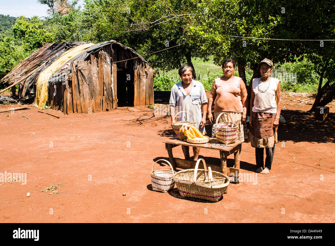 Members of Guarani ethnic group in Xapeco Indian Reserve and some examples of their handicraft work. Stock Photo