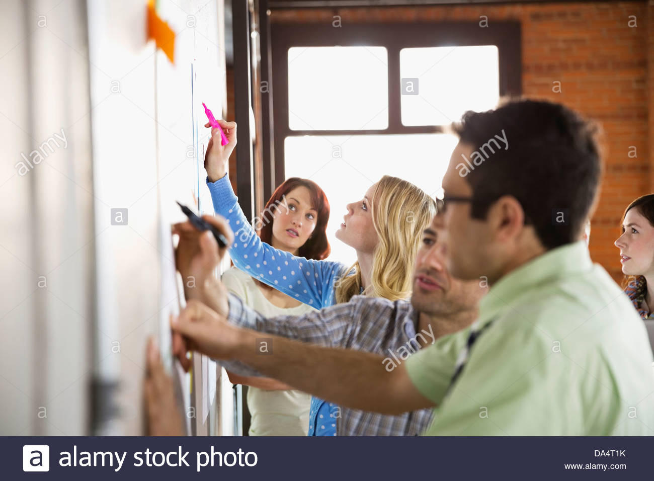 Group of entrepreneurs working on project in creative office space Stock Photo