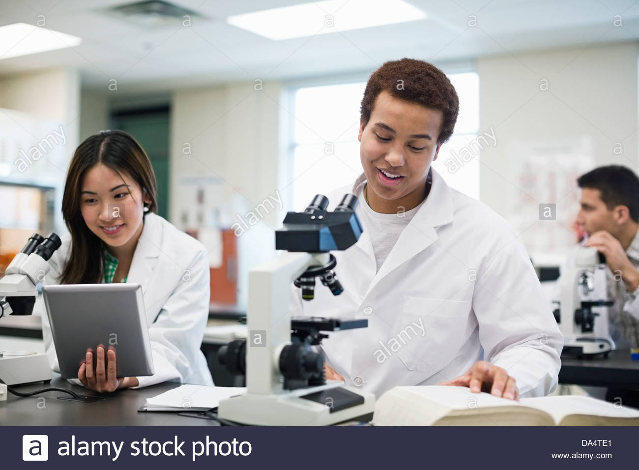 Students using microscopes in college science lab Stock Photo Alamy