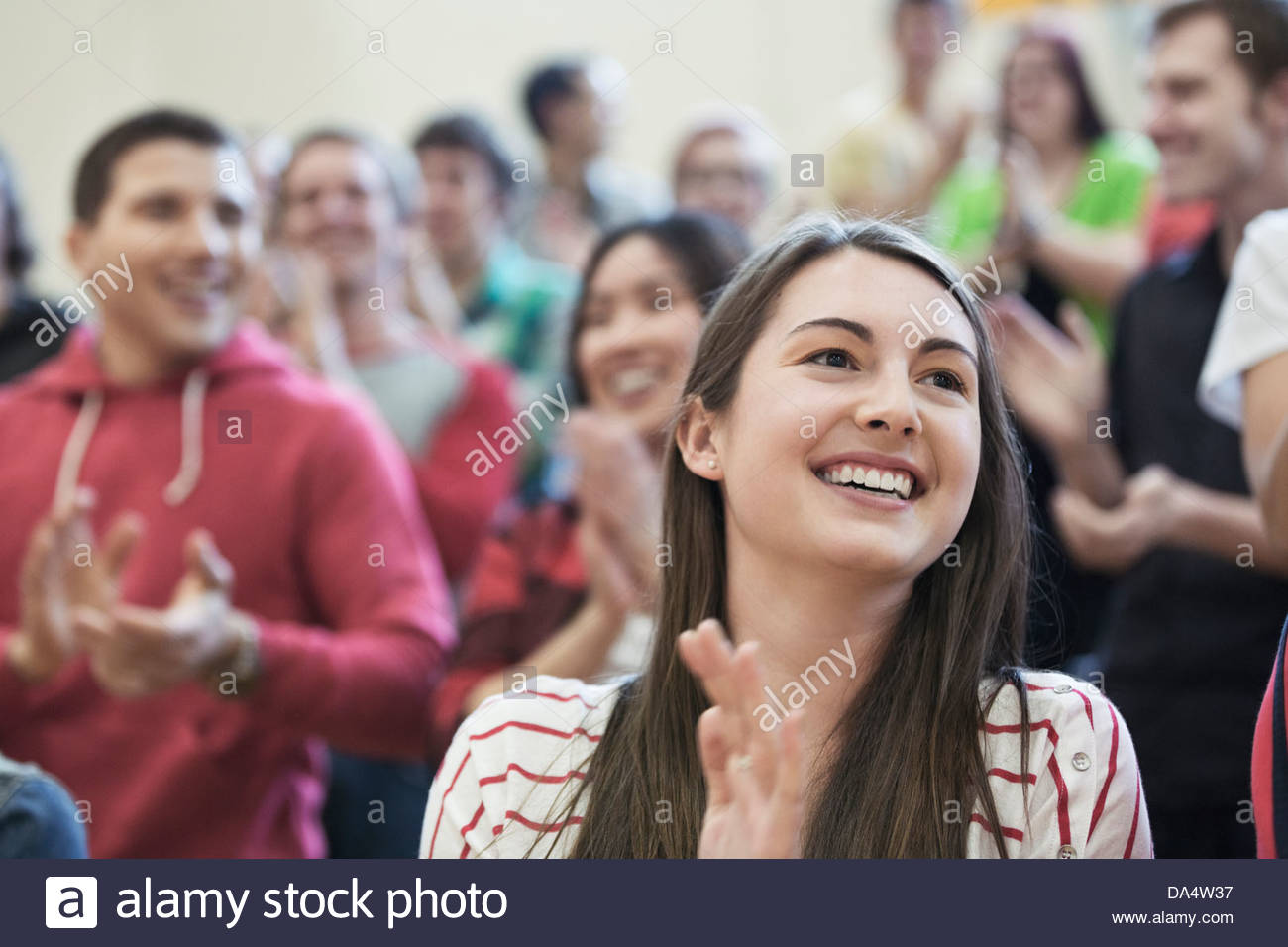 Female student clapping at college sporting event Stock Photo