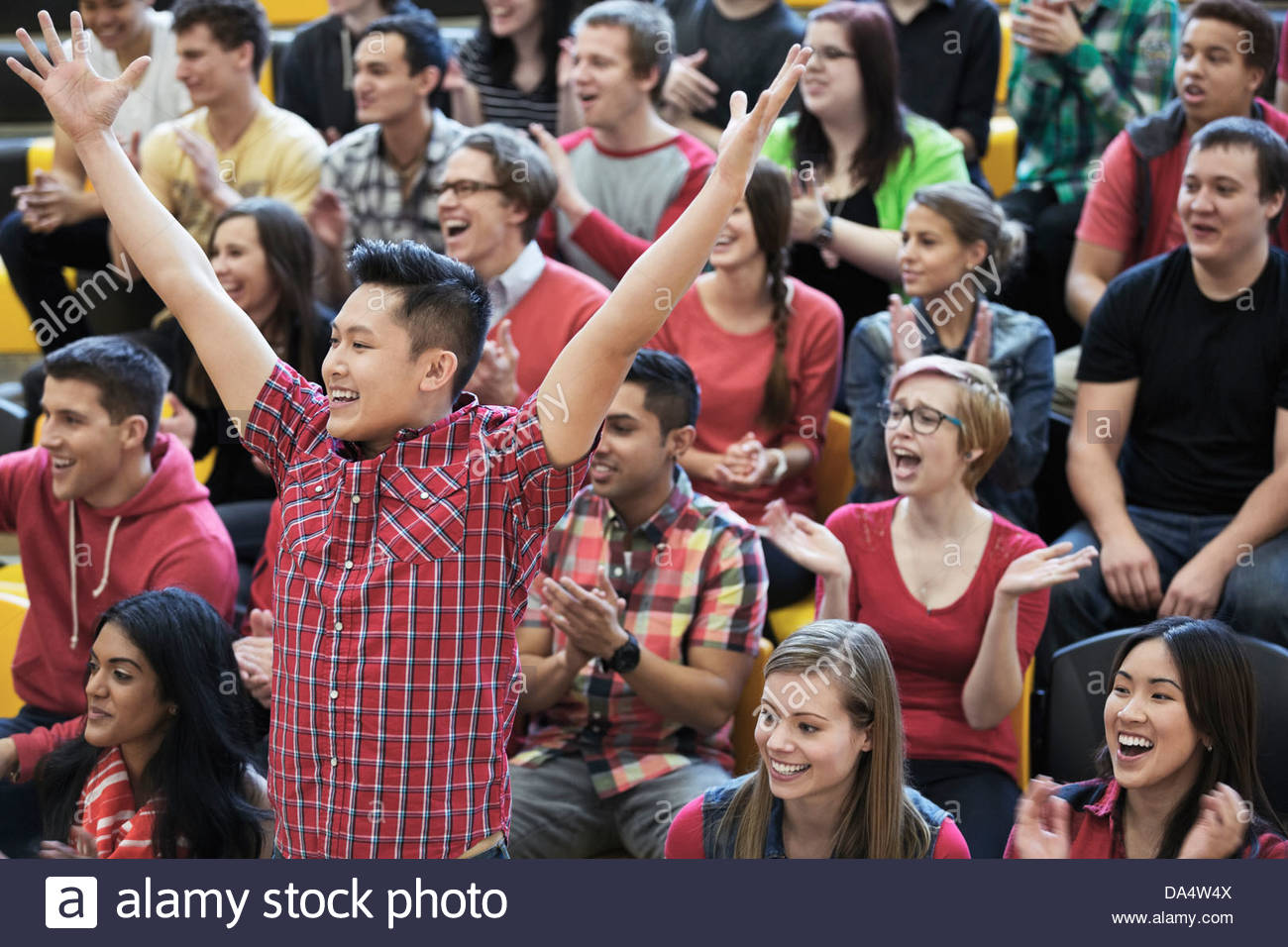Male student cheering at college sporting event Stock Photo