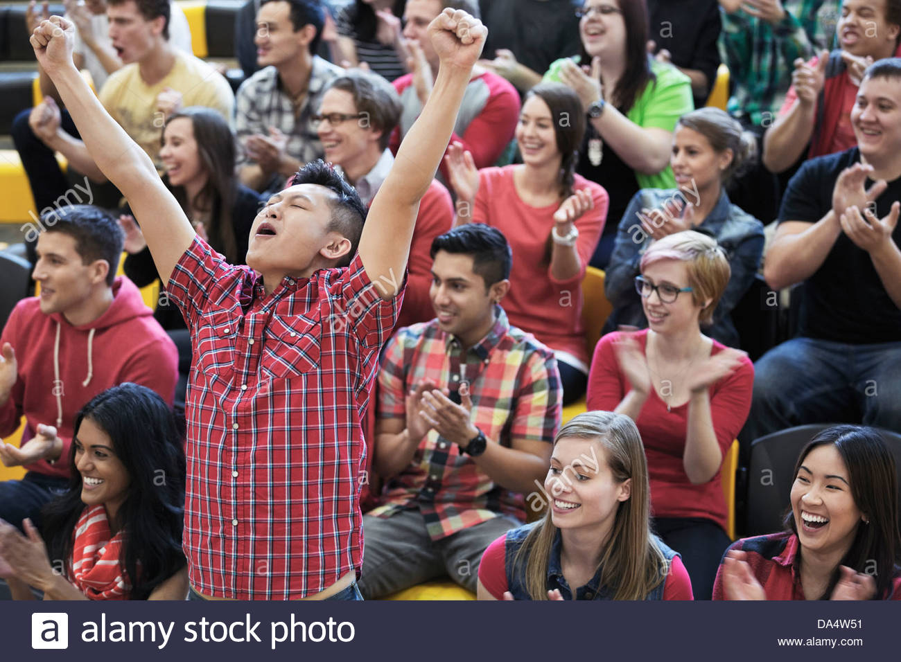 Male student cheering at college sporting event Stock Photo