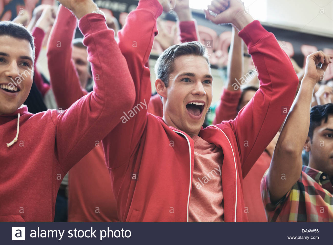 Group of students cheering at college sporting event Stock Photo