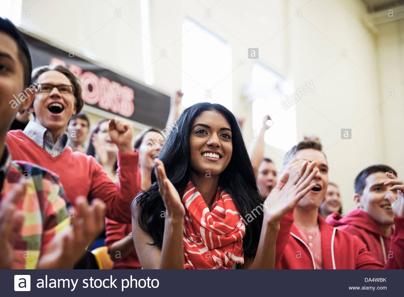 Large group of students cheering at college sporting event Stock Photo