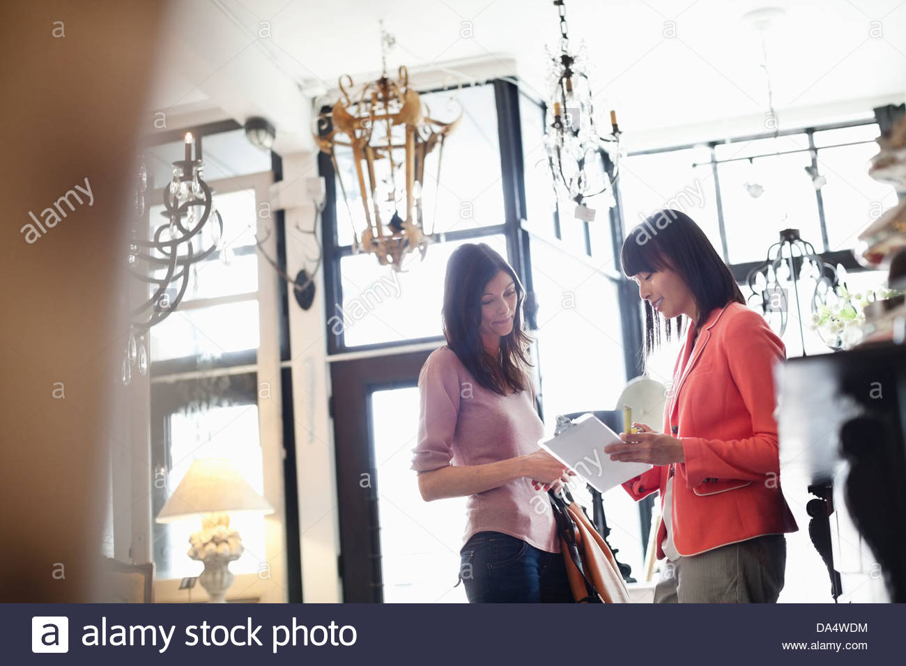 Female business owner helping customer at furniture store Stock Photo