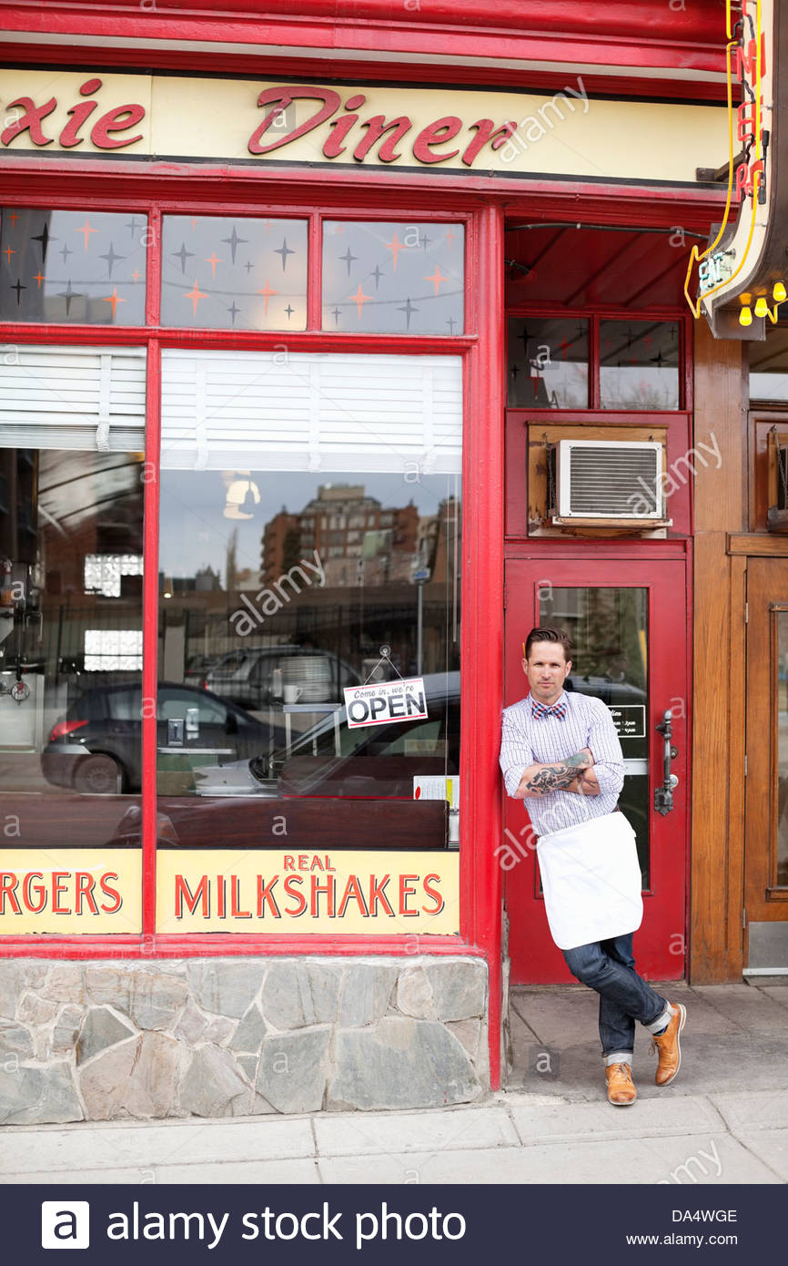 Portrait of male business owner standing outside diner Stock Photo Alamy