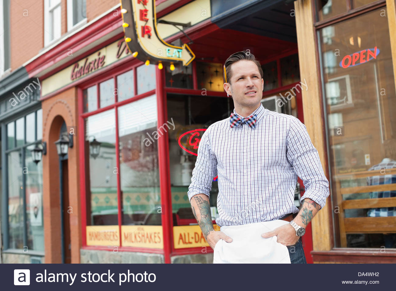 Male business owner standing outside diner Stock Photo Alamy
