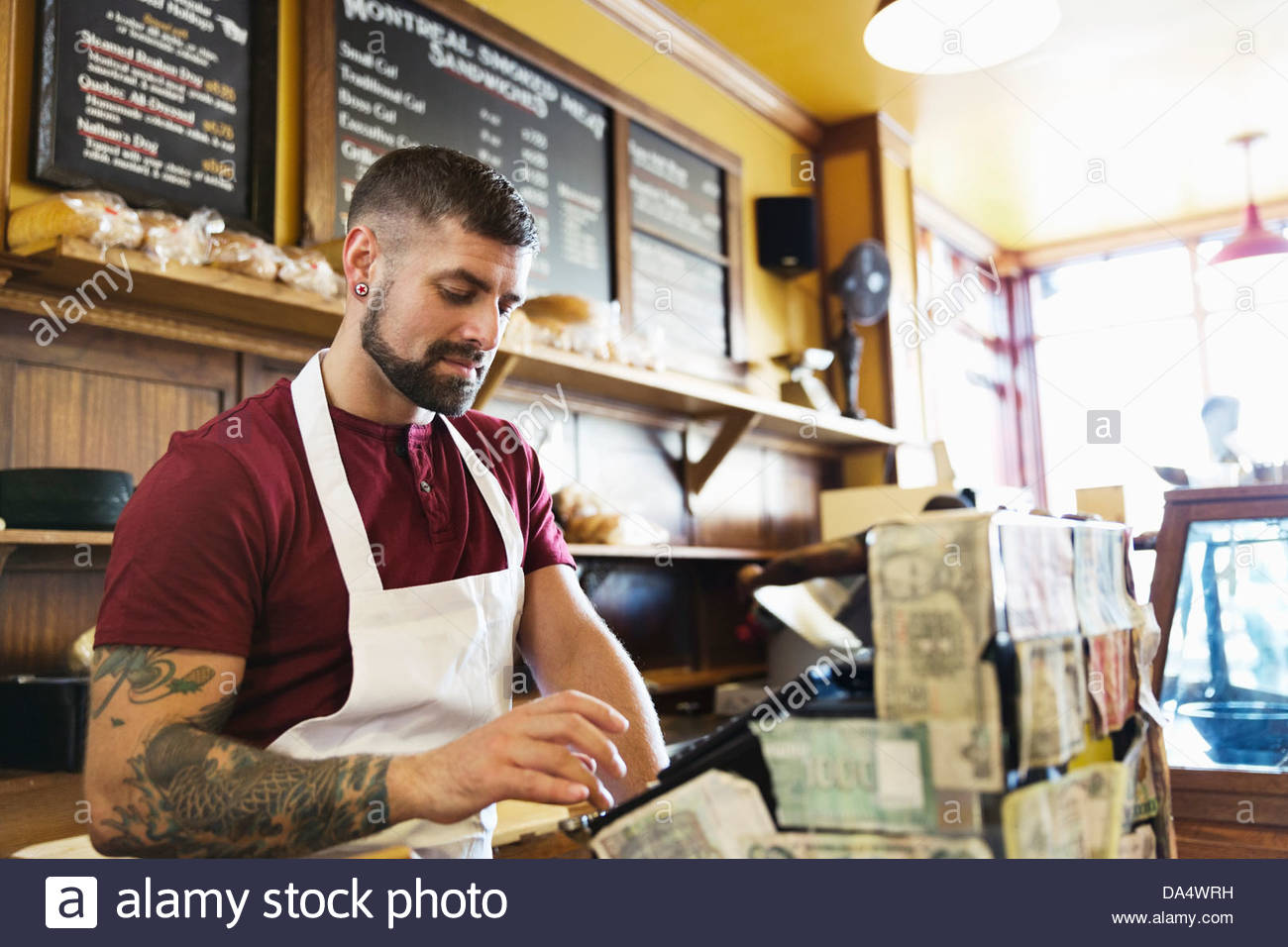 Male deli owner using cash register in restaurant Stock Photo Alamy