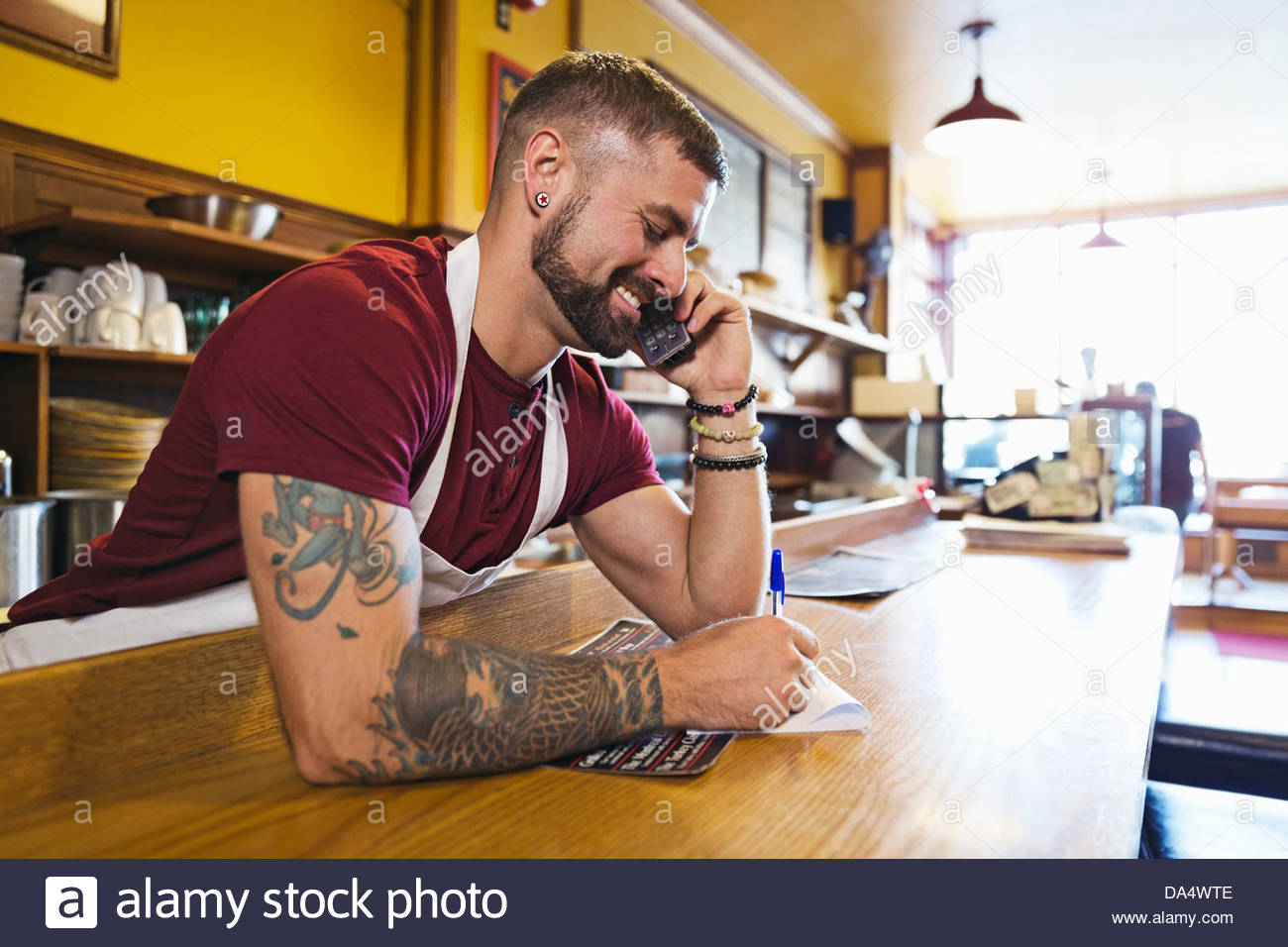 Male deli owner taking order by phone Stock Photo Alamy
