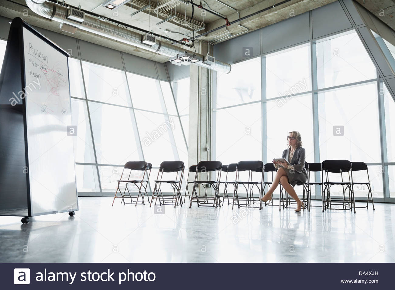 Businesswoman preparing presentation in office meeting room Stock Photo