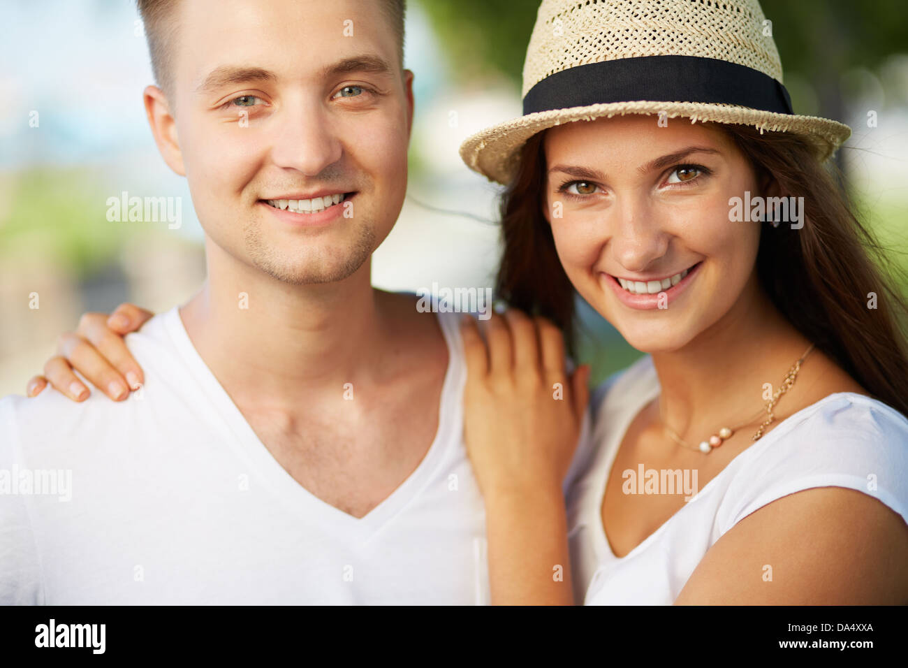 Happy girl and her boyfriend looking at camera Stock Photo - Alamy