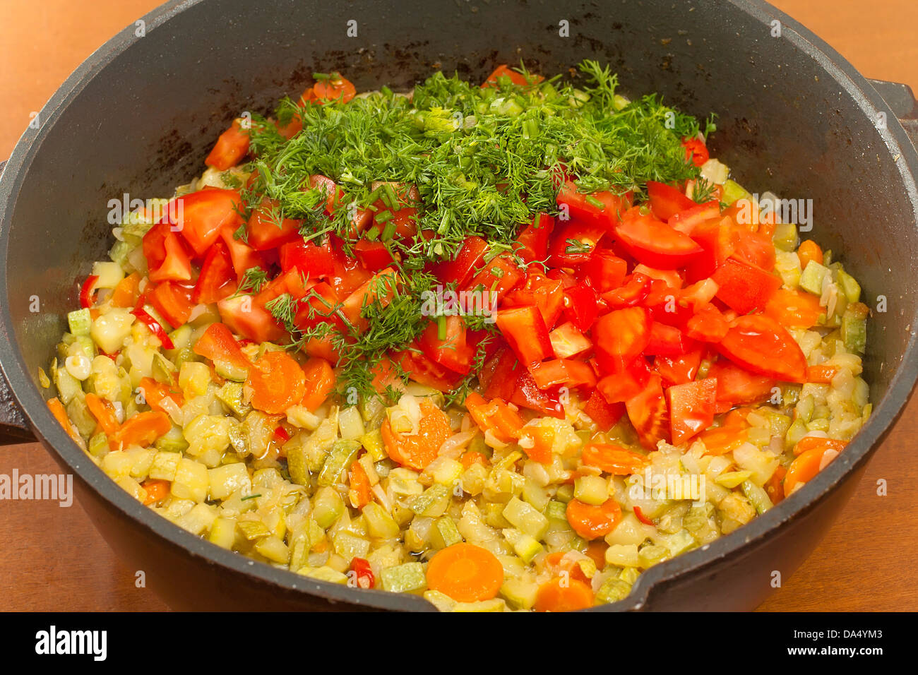cooking saute courgettes in the cauldron Stock Photo