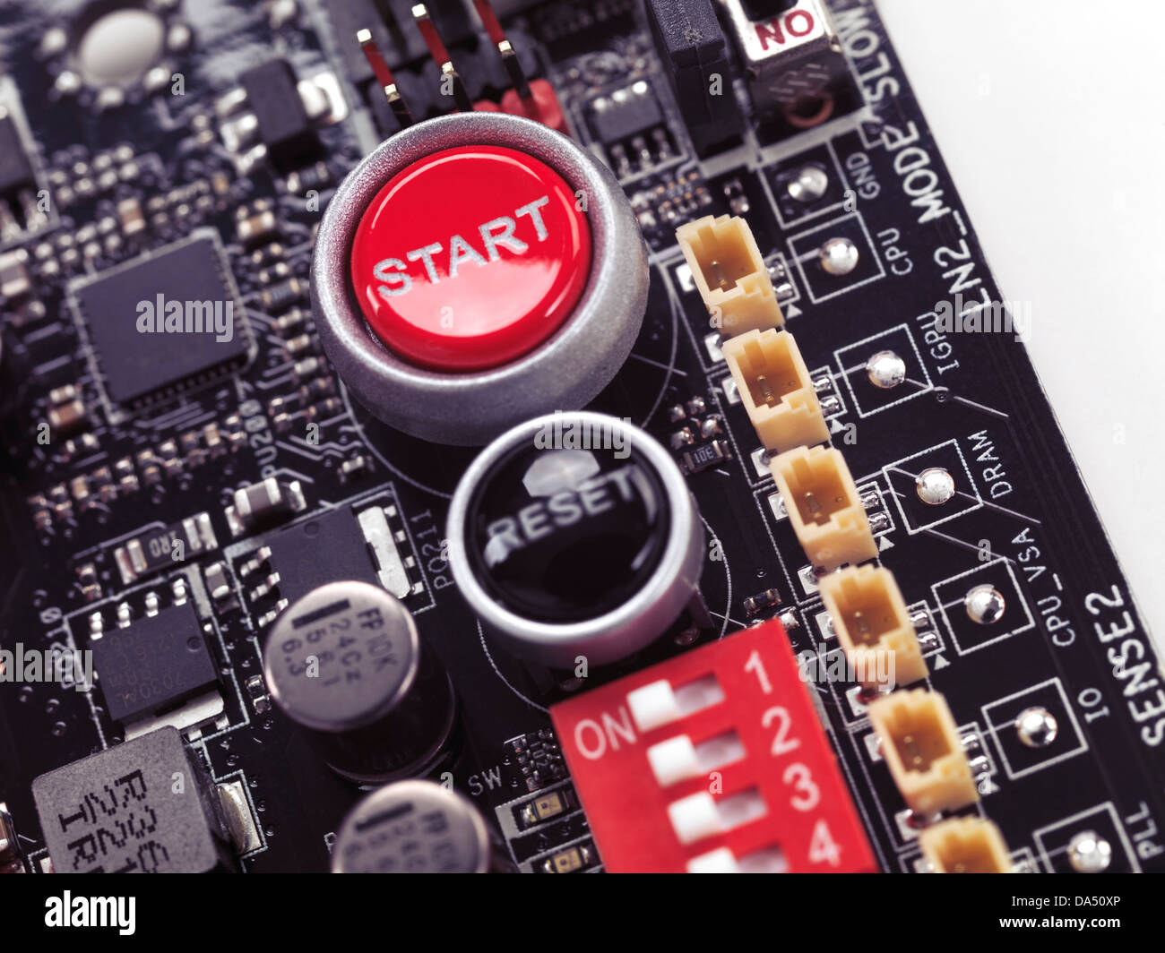 Start and Reset buttons on computer motherboard closeup Stock Photo
