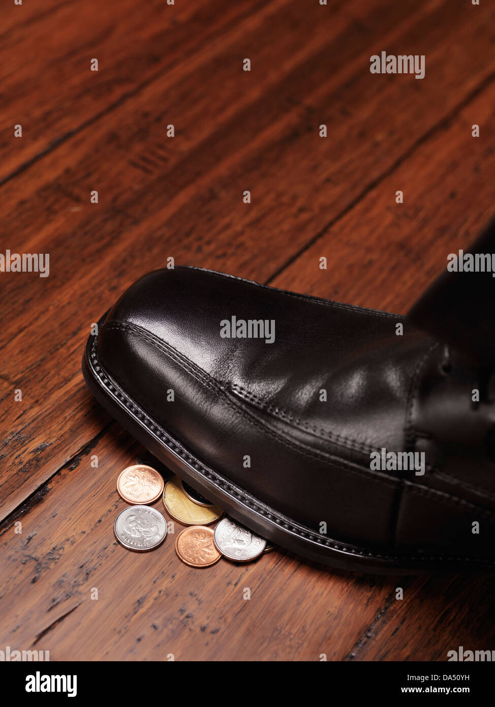 Closeup of a man shoe standing on change, coins, money found on the floor concept Stock Photo