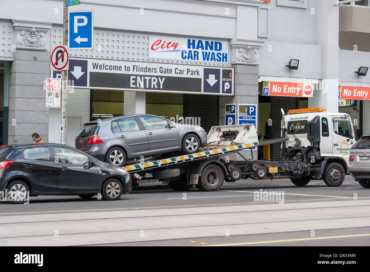 A car is towed from a no parking zone in Flinders Street in downtown