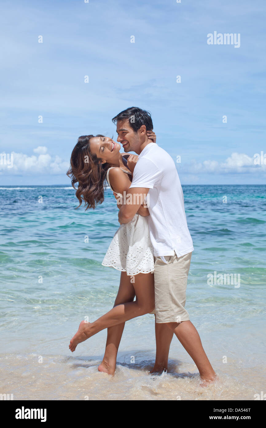 A young couple posing on a beach Stock Photo Alamy — free download