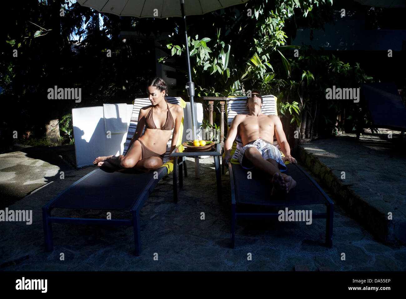 A couple relaxing poolside. Stock Photo