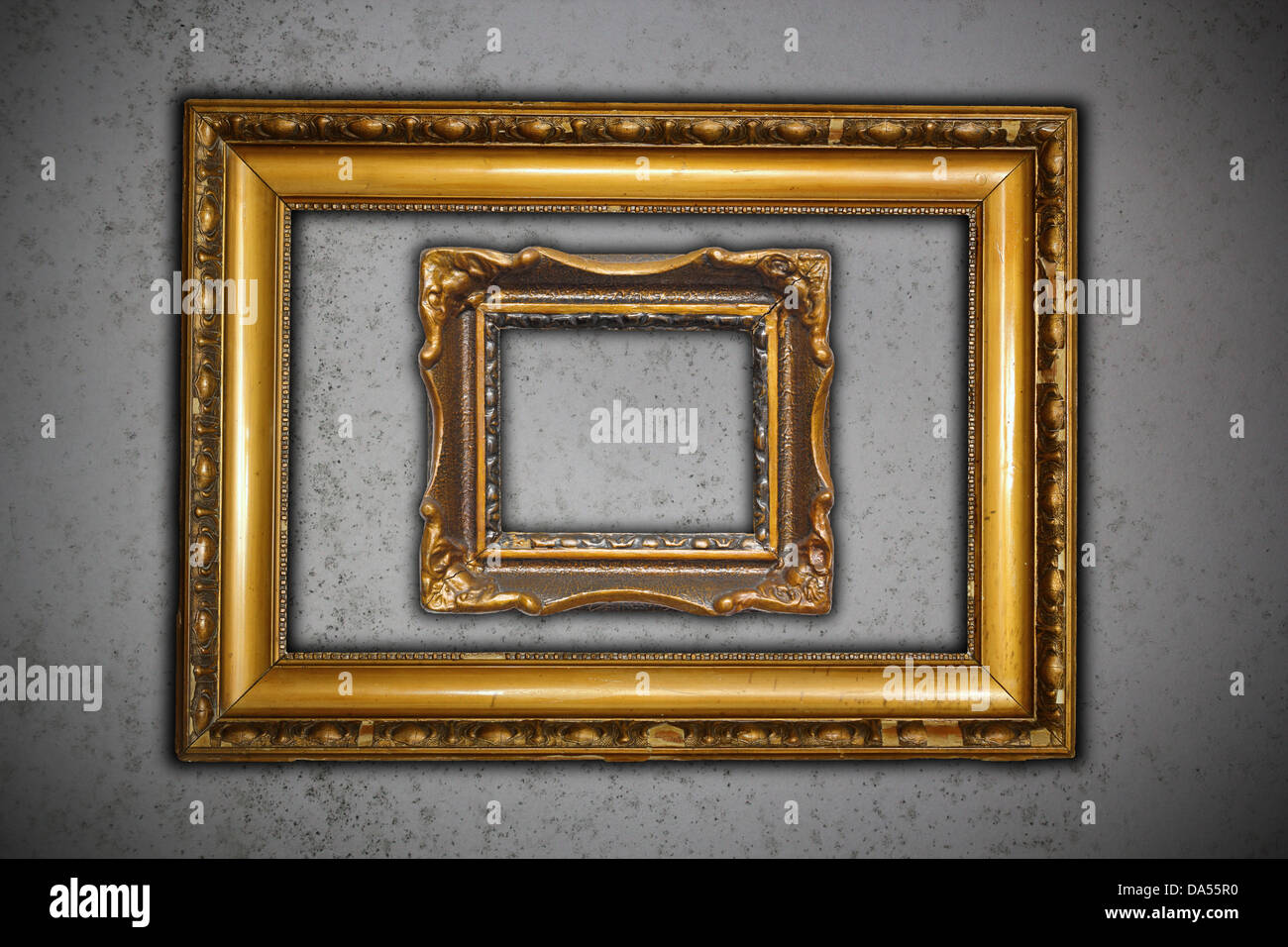 two ancient carved on wood frames for paintings on grungy cement wall
