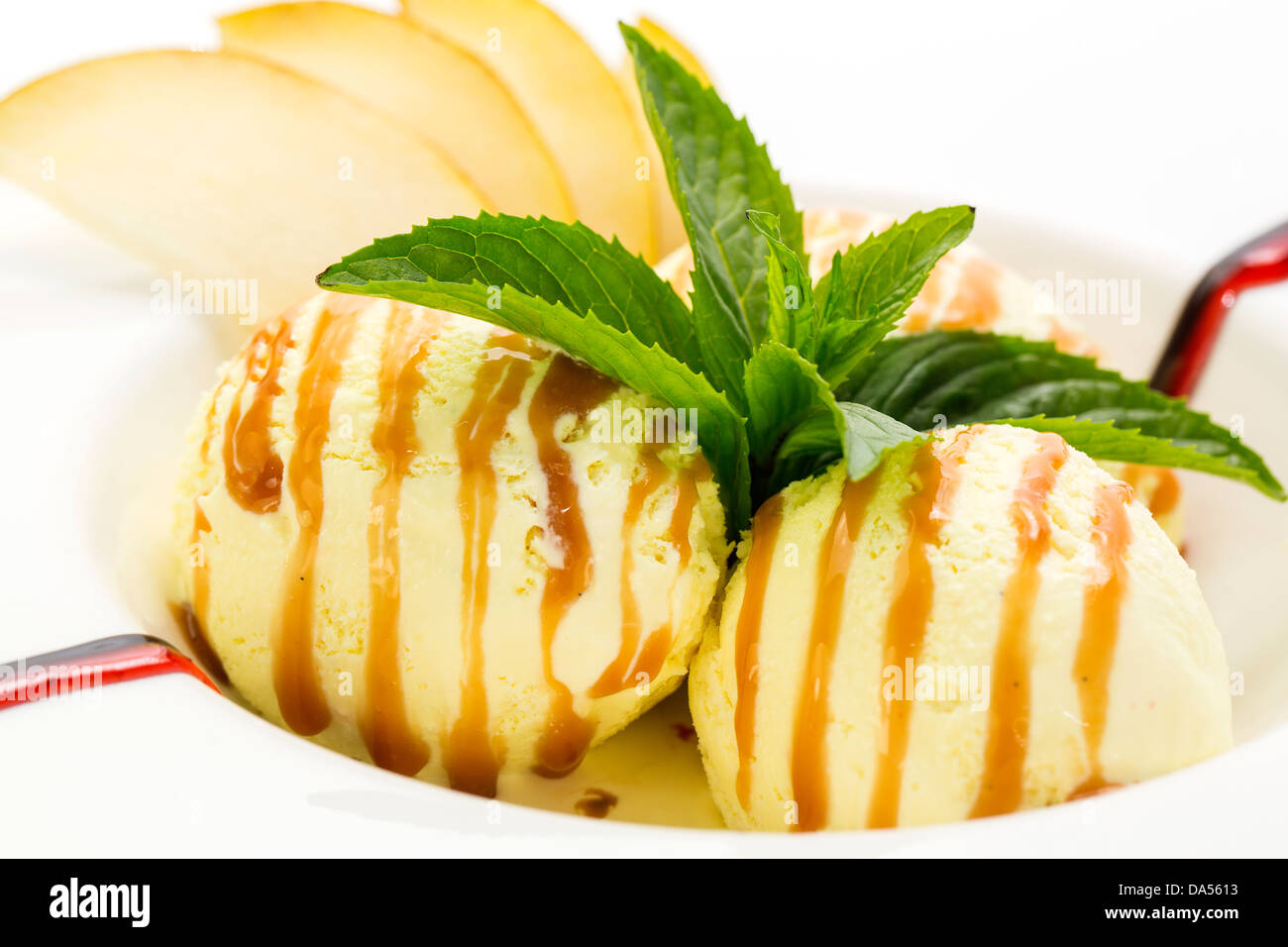 ice cream with caramel sauce and mint on a white background Stock Photo ...