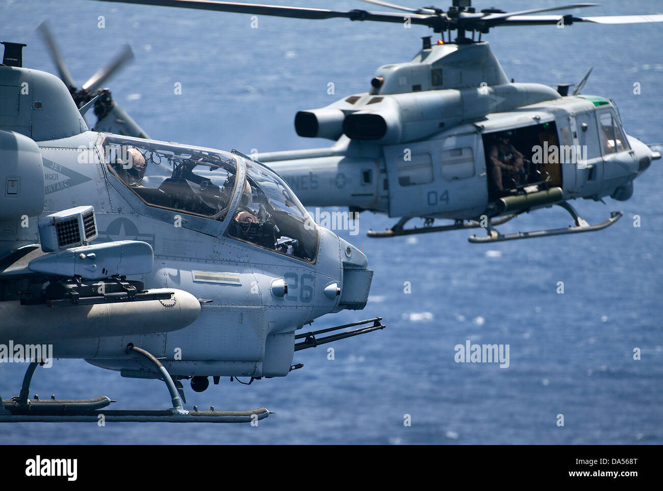US Marine Corps UH-1W Super cobra helicopter and UH-1Y Venom in formation fly over Kaneohe Bay June 13, 2013 in Oahu, Hawaii. Stock Photo