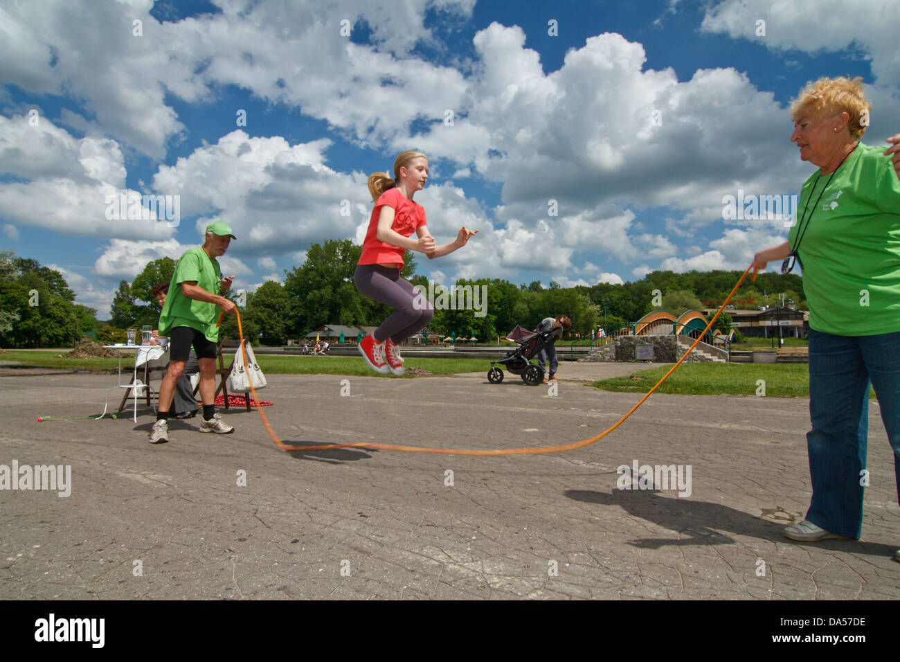 Girl jumping over a skipping rope Stock Photo - Alamy